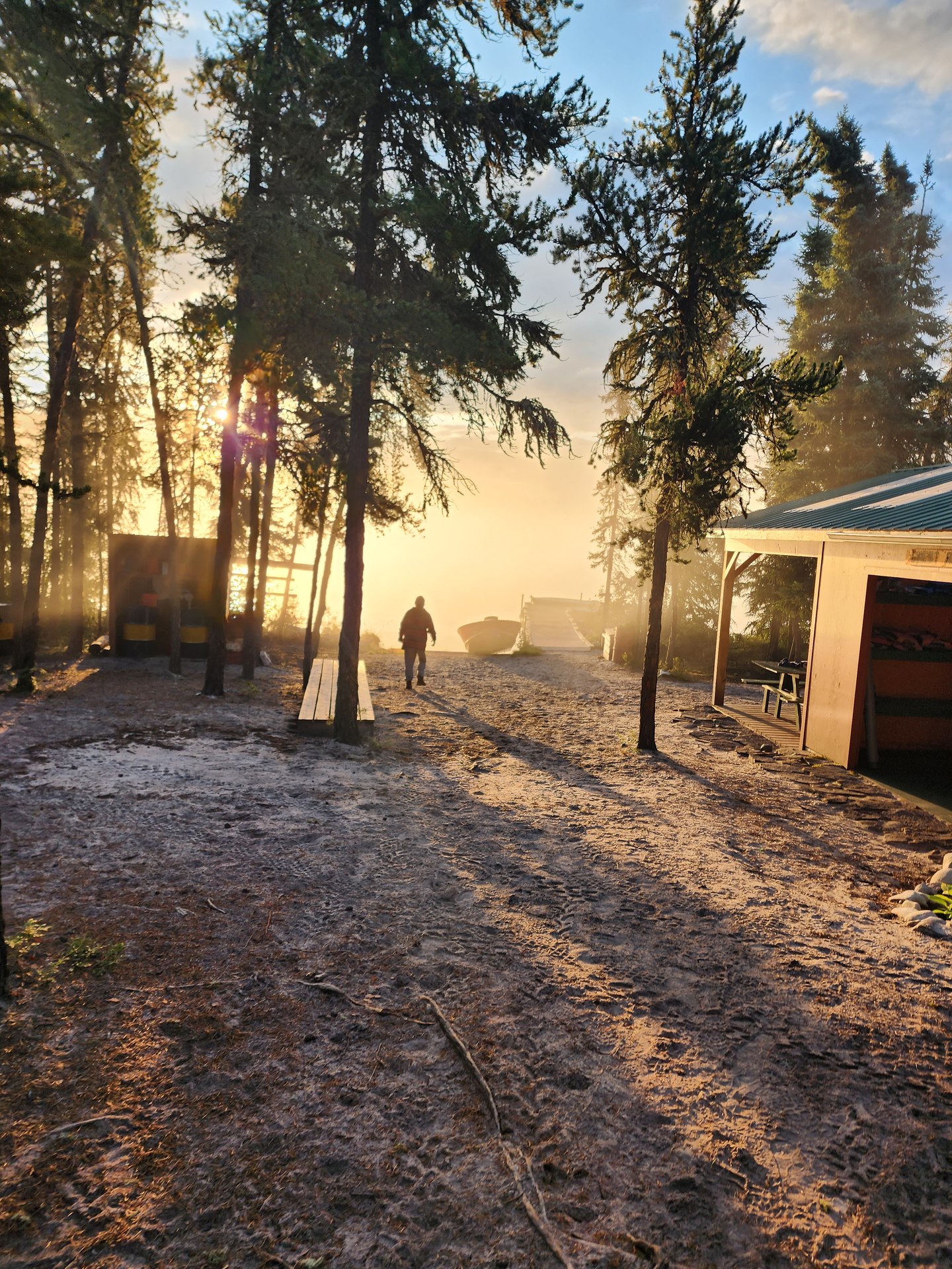 Sunrise over the camp buildings and boats at Plaisted Camps, Russell Lake, Saskatchewan