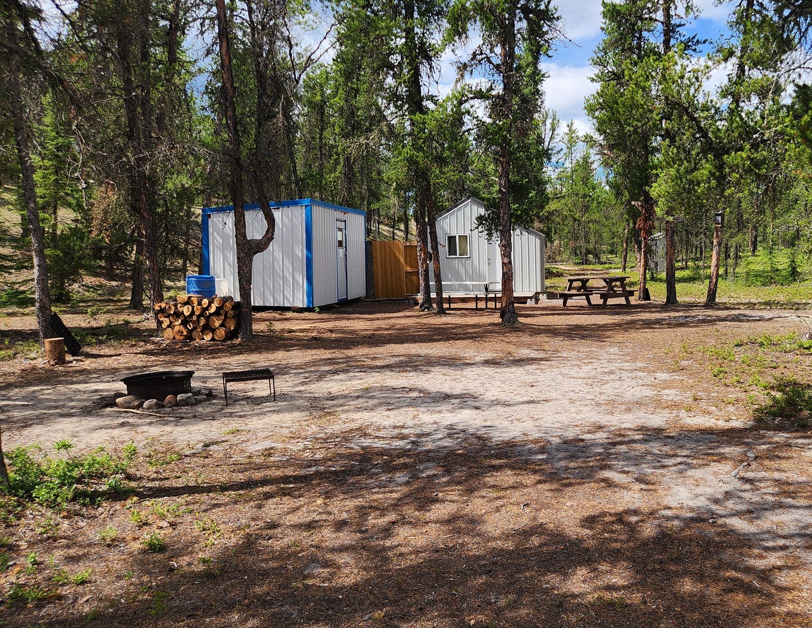 Outcamp cabins, fire pit and picnic table in the pines on the Wheeler River, Saskatchewan